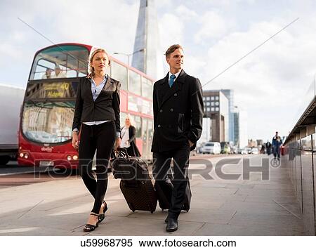 Stock Photography - Businessman and businesswoman on business trip, London, UK. Fotosearch