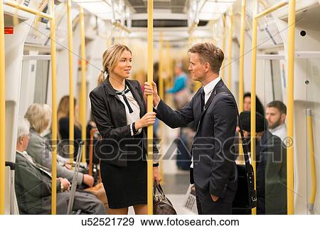 Businessman and businesswoman talking in tube, London Underground, UK View Large Photo Image Stock Photo - Businessman and businesswoman talking in tube, London Underground, UK. Fotosearch