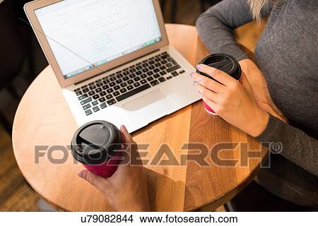 Businessman and businesswoman using laptop in cafe View Large Photo Image Picture - Businessman and businesswoman using laptop in cafe. Fotosearch