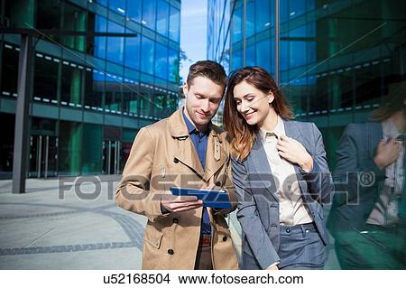 Businessman and woman using digital tablet View Large Photo Image Picture - Businessman and woman using digital tablet. Fotosearch