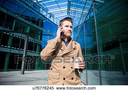 Stock Photography - Businessman on smartphone. Fotosearch