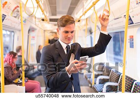 Businessman texting on tube, London Underground, UK View Large Photo Image Stock Photo - Businessman texting on tube, London Underground, UK. Fotosearch