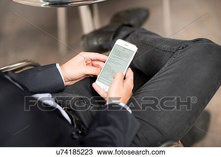 Stock Image - Businessman texting. Fotosearch