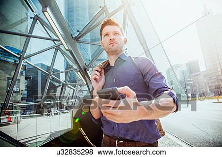 Businessman using smartphone View Large Photo Image Stock Photo - Businessman using smartphone. Fotosearch