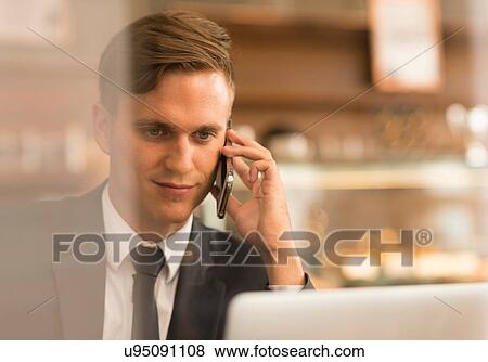 Businessman working on laptop in cafe View Large Photo Image Stock Photo - Businessman working on laptop in cafe. Fotosearch