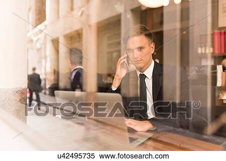 Businessman working on laptop in cafe View Large Photo Image Stock Photography - Businessman working on laptop in cafe. Fotosearch