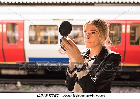 Businesswoman powdering nose, London Underground, UK View Large Photo Image Stock Photo - Businesswoman powdering nose, London Underground, UK. Fotosearch