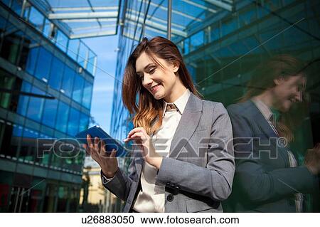 Stock Image - Businesswoman using digital tablet. Fotosearch