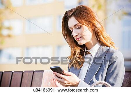 Businesswoman using smartphone View Large Photo Image Stock Image - Businesswoman using smartphone. Fotosearch