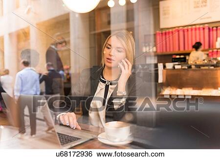 Businesswoman working on laptop in cafe View Large Photo Image Stock Photograph - Businesswoman working on laptop in cafe. Fotosearch