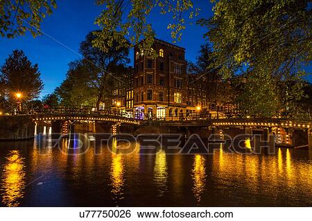 Canal waterfront and bridge at night, Amsterdam, Netherlands View Large Photo Image Stock Photograph - Canal waterfront and bridge at night, Amsterdam, Netherlands. Fotosearch