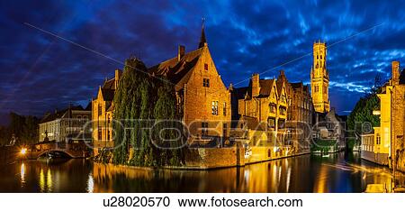 Stock Image - Canal waterfront and historic buildings at night, Bruges, Belgium. Fotosearch
