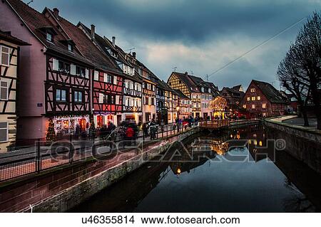 Picture - Canal waterfront view of traditional townhouses at dusk, Colmar, France. Fotosearch