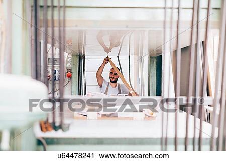 Stock Image - Carpenter in workshop. Fotosearch