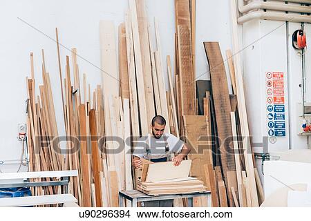 Carpenter selecting wood in workshop View Large Photo Image Picture - Carpenter selecting wood in workshop. Fotosearch