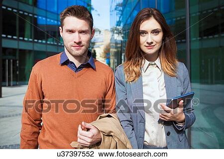 Stock Image - Casual businessman and woman, portrait. Fotosearch