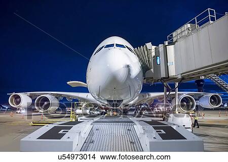 Chief engineer inspecting A380 aircraft on runway at night View Large Photo Image Picture - Chief engineer inspecting A380 aircraft on runway at night. Fotosearch