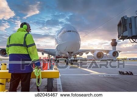 Chief engineer watching A380 aircraft arrive at stand in airport View Large Photo Image Stock Photo - Chief engineer watching A380 aircraft arrive at stand in airport. Fotosearch
