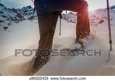 Stock Image - Climber wearing snow shoes walking through deep snow, Monte Rosa, Piedmont, Italy. Fotosearch
