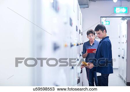 Colleagues in control room testing switchgear with electricity meter View Large Photo Image Stock Image - Colleagues in control room testing switchgear with electricity meter. Fotosearch