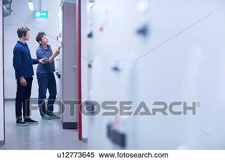 Colleges in control room looking at switchgear View Large Photo Image Stock Photography - Colleges in control room looking at switchgear. Fotosearch