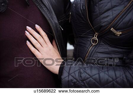 Cropped close up of young womans hand on boyfriends chest View Large Photo Image Stock Image - Cropped close up of young womans hand on boyfriends chest. Fotosearch