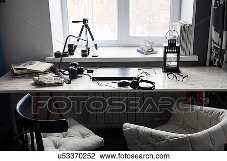 Desk with closed laptop and two chairs View Large Photo Image Stock Image - Desk with closed laptop and two chairs. Fotosearch