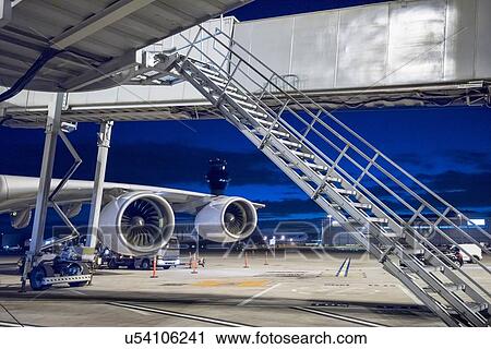 Stock Image - Detail of engine of A380 aircraft on stand at airport at night. Fotosearch