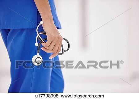 Stock Photo - Doctor holding stethoscope. Fotosearch