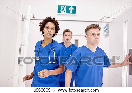Stock Photo - Doctors running into emergency room in hospital. Fotosearch