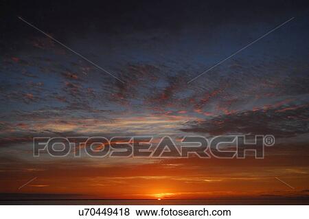 Stock Photo - Dramatic sky and sunrise at dawn, Magdalena Bay, Baja California, Mexico. Fotosearch