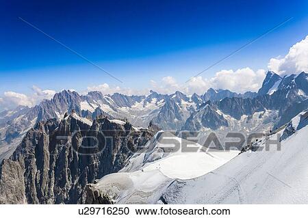 Stock Image - Elevated view of snow covered mountains at Mont blanc, France. Fotosearch