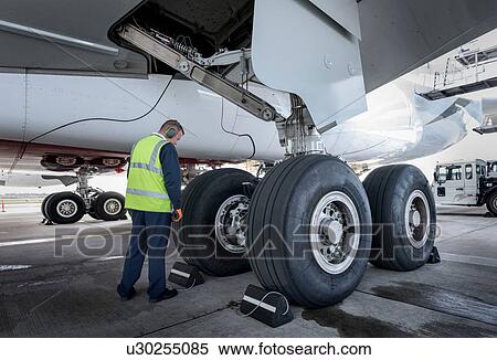Engineer inspecting A380 aircraft at stand in airport View Large Photo Image Stock Photography - Engineer inspecting A380 aircraft at stand in airport. Fotosearch