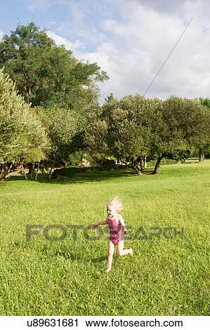 Female toddler wearing bathing suit running in field View Large Photo Image Stock Image - Female toddler wearing bathing suit running in field. Fotosearch