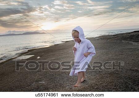 Female toddler wearing hooded robe on beach, Calvi, Corsica, France View Large Photo Image Stock Image - Female toddler wearing hooded robe on beach, Calvi, Corsica, France. Fotosearch