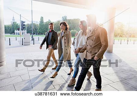 Four mid adult friends walking together View Large Photo Image Stock Image - Four mid adult friends walking together. Fotosearch