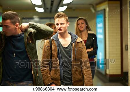 Four young adult friends walking through London underground station, London, UK View Large Photo Image Picture - Four young adult friends walking through London underground station, London, UK. Fotosearch