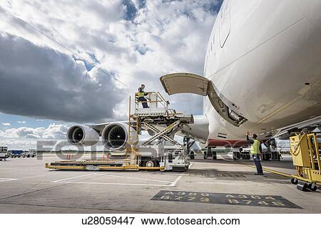 Freight handling machinery with A380 aircraft View Large Photo Image Stock Photo - Freight handling machinery with A380 aircraft. Fotosearch