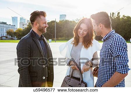 Stock Photo - Friends meeting in town square. Fotosearch