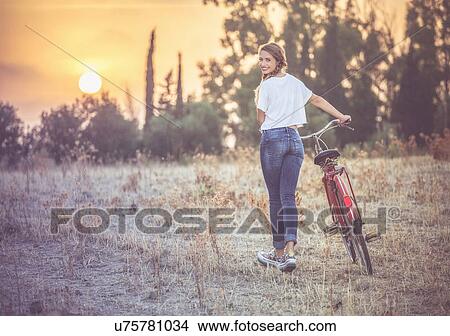 Girl walking her bike in countryside, Quartucciu, Sardinia, Italy View Large Photo Image Picture - Girl walking her bike in countryside, Quartucciu, Sardinia, Italy. Fotosearch