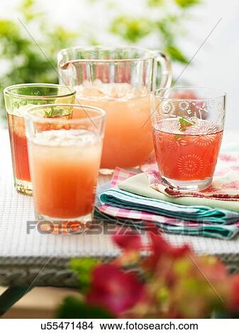 Picture - Glasses of fresh home made fruit drinks and ice. Fotosearch