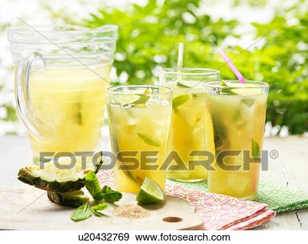 Glasses of home made golden rum punch with lime, pineapple, mint and ice View Large Photo Image Stock Photo - Glasses of home made golden rum punch with lime, pineapple, mint and ice. Fotosearch