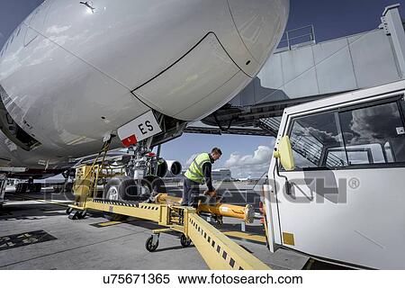 Stock Photography - Ground crew attaching tow bar to A380 aircraft. Fotosearch