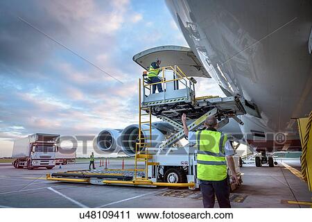 Ground crew attending to A380 aircraft with freight loader at airport View Large Photo Image Stock Image - Ground crew attending to A380 aircraft with freight loader at airport. Fotosearch