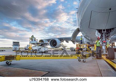 Stock Photo - Ground crew attending to A380 aircraft at airport. Fotosearch