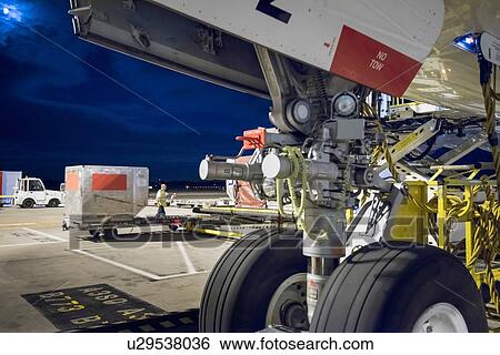 Stock Photograph - Ground crew attending to A380 aircraft at airport. Fotosearch
