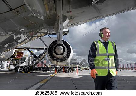 Stock Photography - Ground crew engineer with A380 jet aircraft. Fotosearch