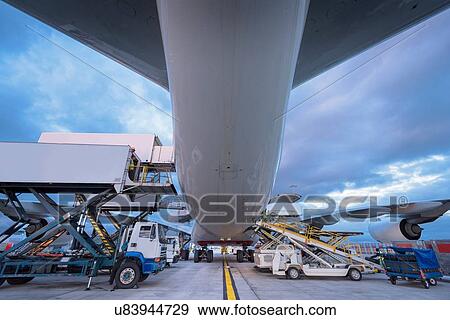 Stock Photo - Ground crew loading A380 aircraft at airport. Fotosearch