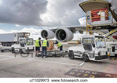 Ground crew loading freight onto A380 aircraft View Large Photo Image Stock Image - Ground crew loading freight onto A380 aircraft. Fotosearch