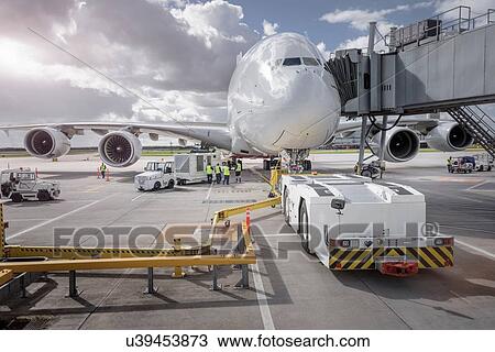 Stock Image - Ground crew operating loading equipment on A380 aircraft. Fotosearch